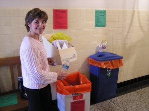 Brooke Kingsley placing plastic bottle and paper in recycling collection containers