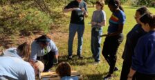 Students and faculty working on a sustainability project outdoors