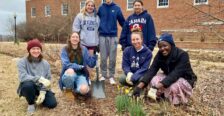 Group photo of students after they've planted flowers.