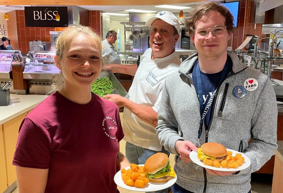Students in the dining hall posing with their plates