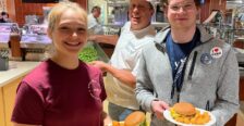 Students in the dining hall posing with their plates